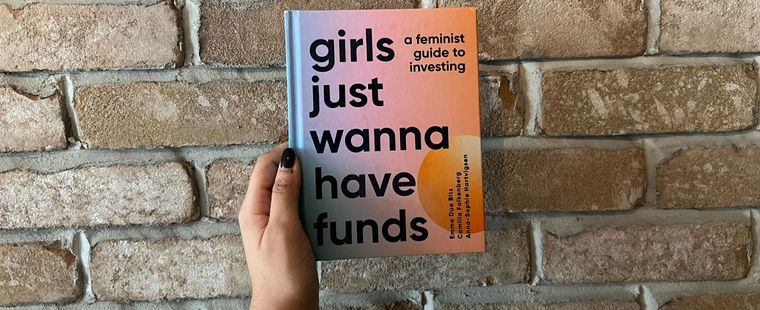 Hand holding Girls Just Wanna Have Funds Book