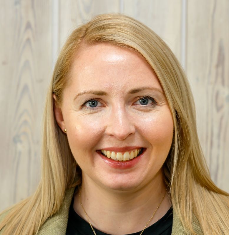 Headshot image of Emma smiling at the camera